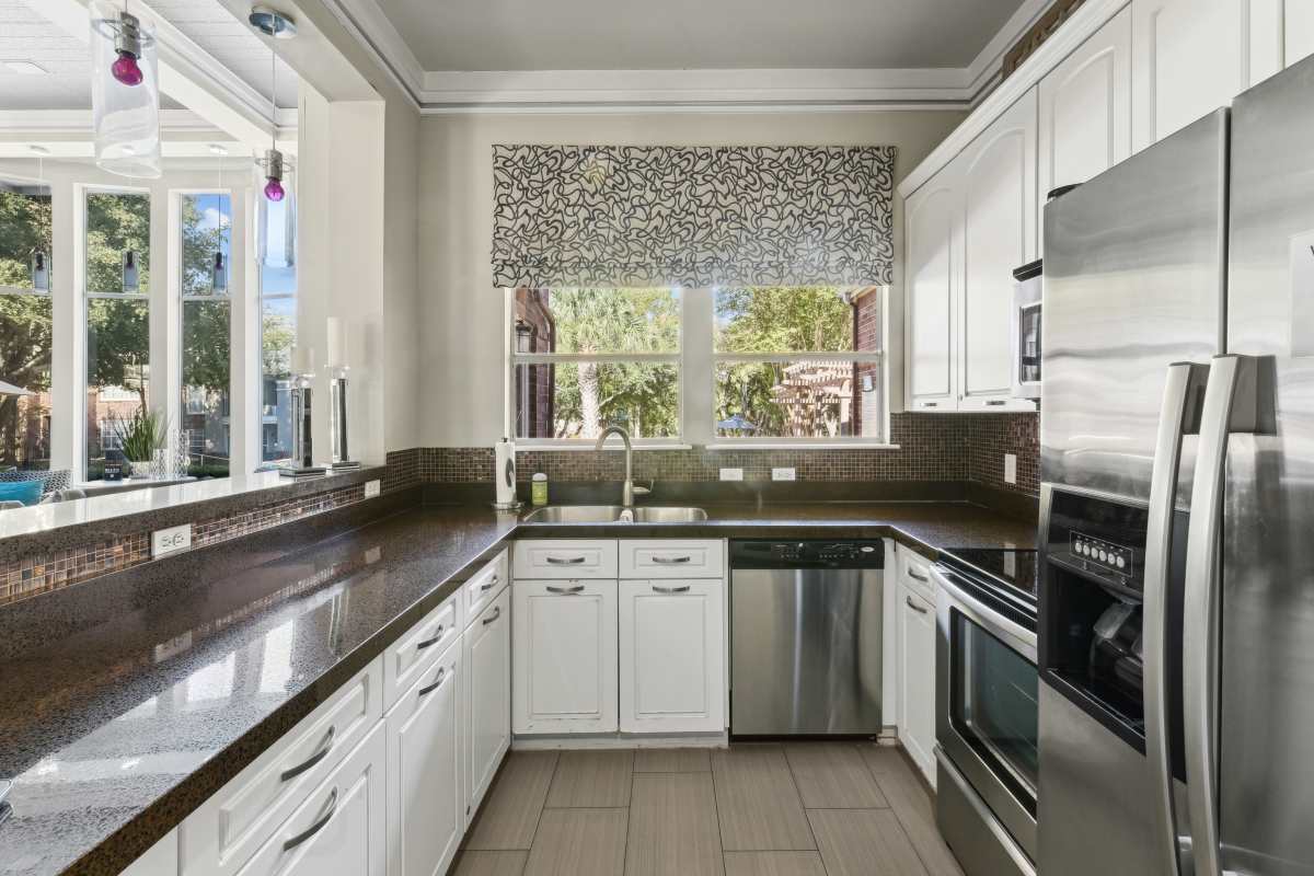 Modern Kitchen With White Cabinets And Stainless Steel Appliances at Whispering Creek Villas, San Antonio, Texas