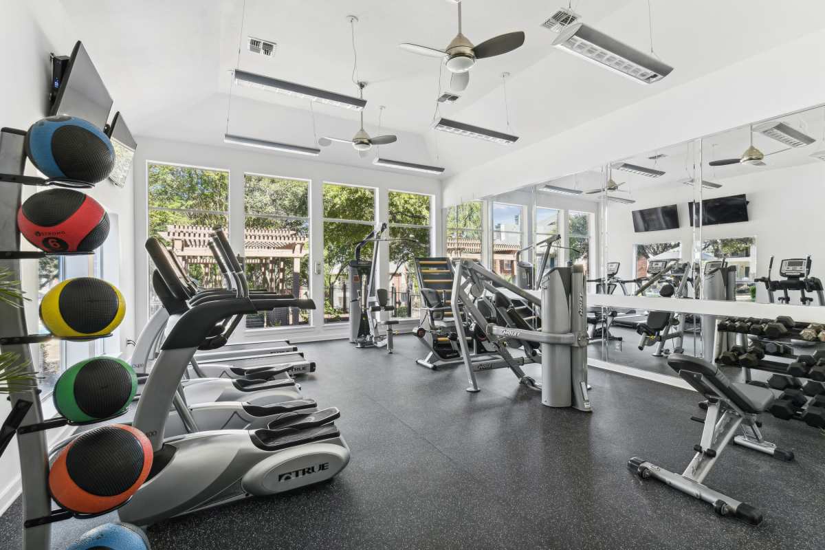 Spacious Gym With A Variety Of Exercise Equipment And Mirrored Walls at Whispering Creek Villas, San Antonio, Texas