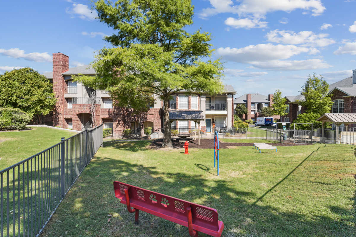 Park With A Red Bench And Play Equipment at Whispering Creek Villas, San Antonio, Texas