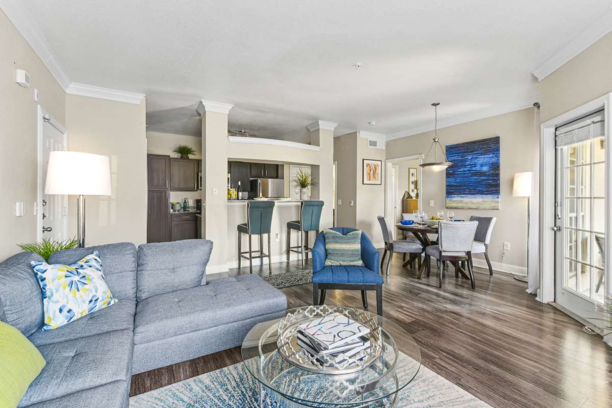Open-Concept Living Space With A Kitchen Bar And Dining Area at Whispering Creek Villas, San Antonio, Texas