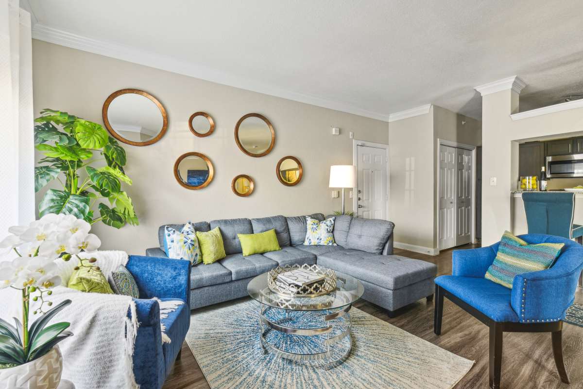 Stylish Living Room With Decorative Mirrors And Comfortable Seating at Whispering Creek Villas, San Antonio, Texas