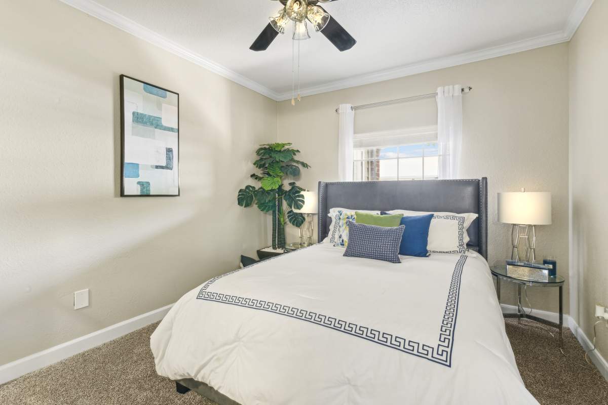 Comfortably Furnished Bedroom With A Queen-Sized Bed And Nightstands at Whispering Creek Villas, San Antonio, Texas