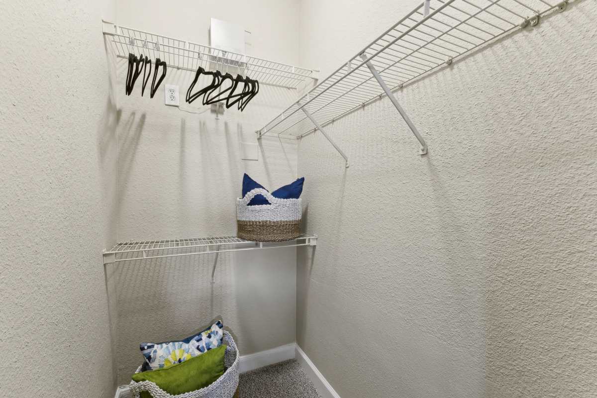 Walk-In Closet With Wire Shelving And Storage Baskets at Whispering Creek Villas, San Antonio, Texas