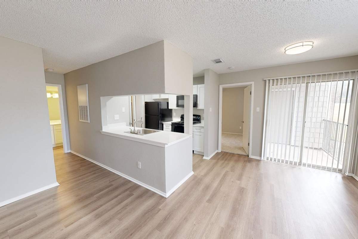 Living space with wood-like plank flooring at Hunters Glen in Killeen, Texas