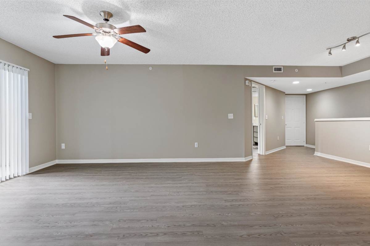 Living room with ceiling fan at The Allara Apartments, Boynton Beach, Florida
