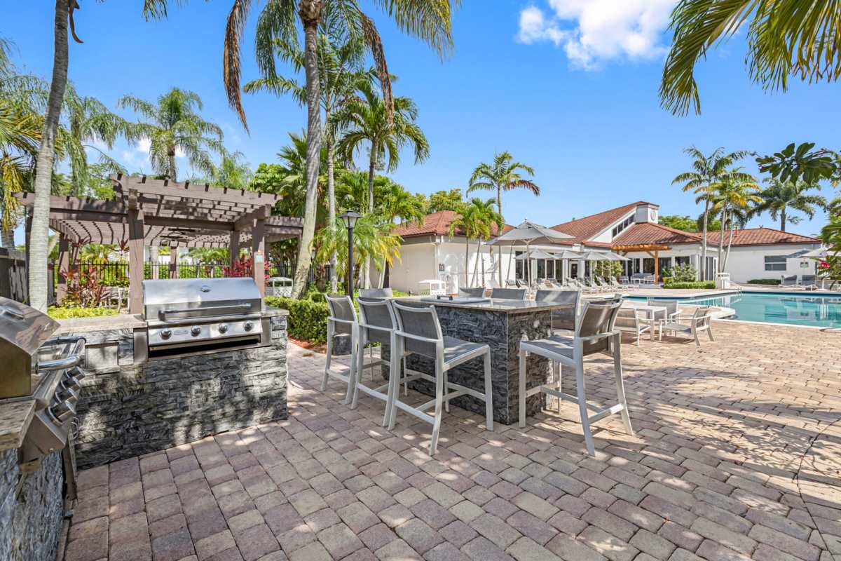 Seating area by the pool at Centro at Davie Apartments in Davie,Florida