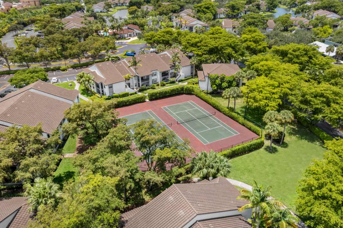 Aerial shot of the community tennis court at Centro at Davie Apartments in Davie,Florida