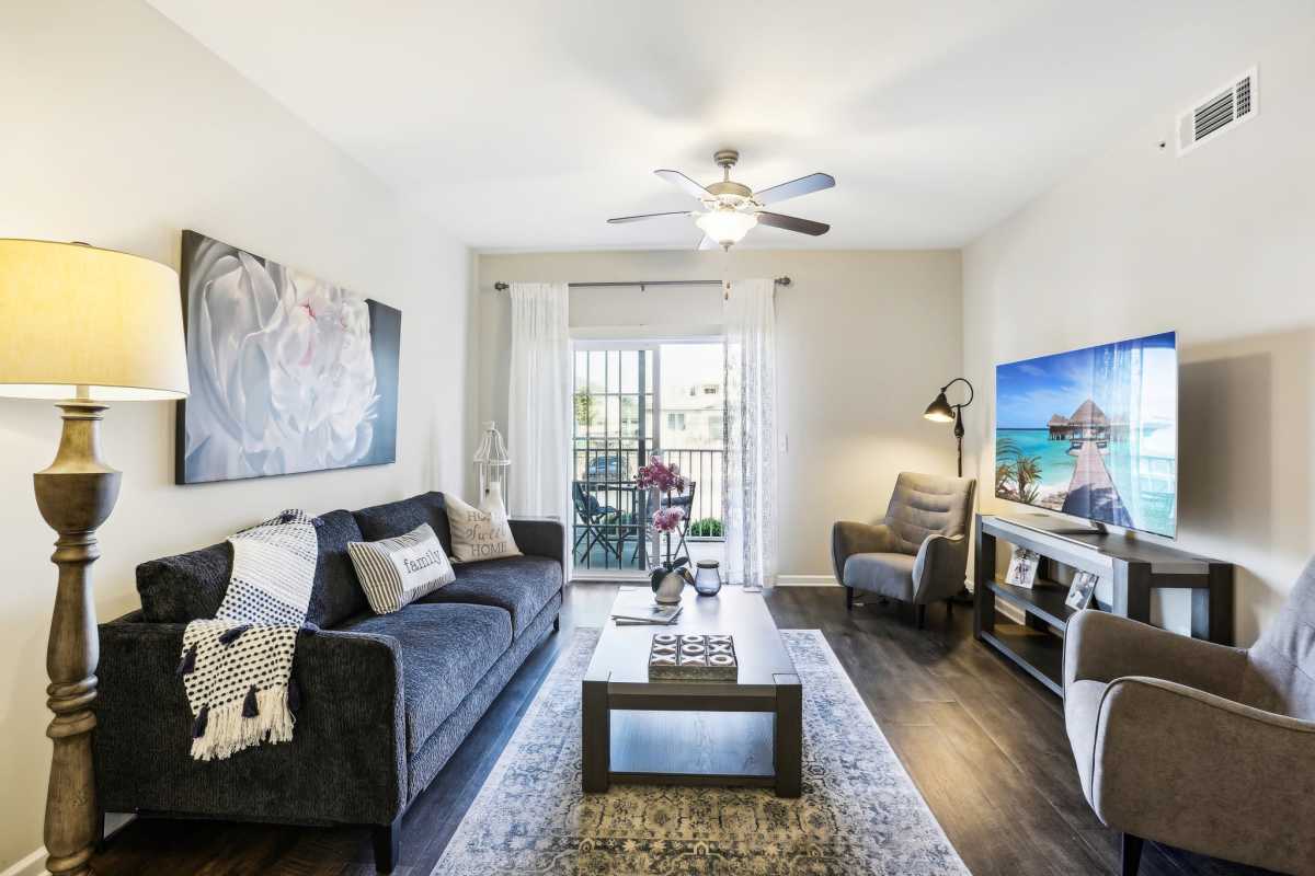 Living room with couches ceiling fan at The Retreat at Arden Village Apartments in Columbia, Tennessee