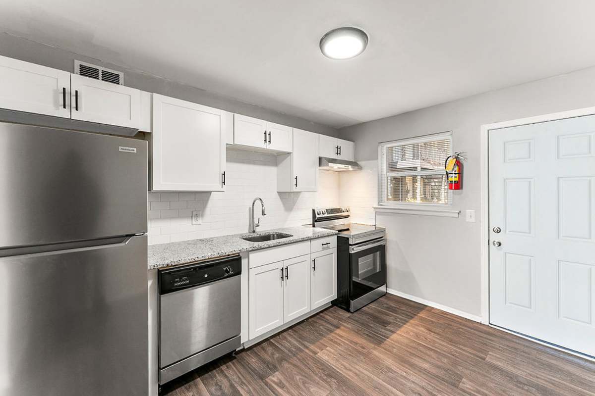 Cozy kitchen with white cabinetry and stainless-steel appliances at Gardens at Washington Park in Atlanta,Georgia