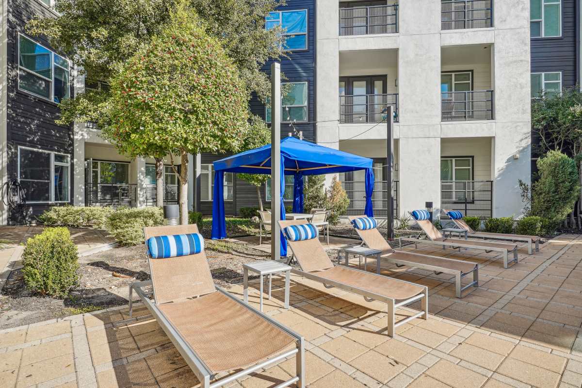 Swimming pool and patio with lounge chairs at Century Medical District, Dallas, Texas