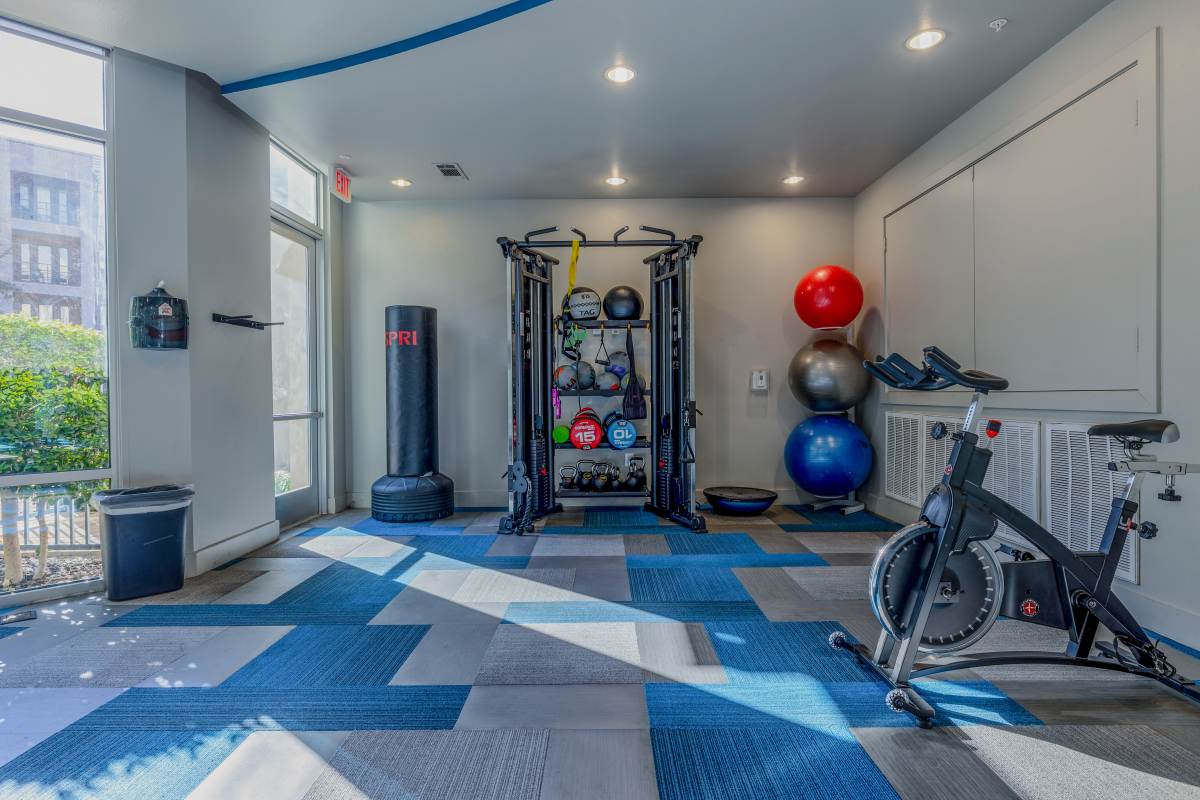 Well-lit fitness gym at Century Medical District in Dallas, Texas