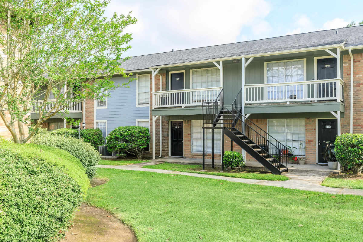 Woman on top of a building looking over the city at Arbor Pines Villas in Angleton, Texas