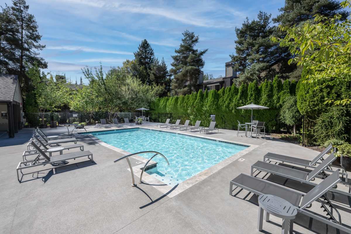 Sun loungers by the poolside at Campbell Run Apartments in Woodinville, Washington