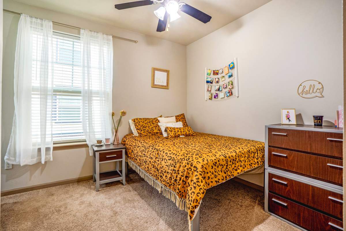 Well-lit private bedroom at The Den in Columbia, Missouri