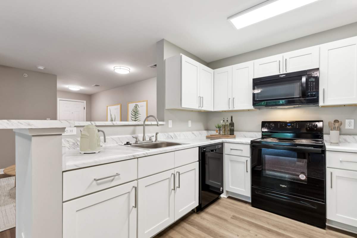 Kitchen with black appliances at Barrington Parc in Moody, Alabama