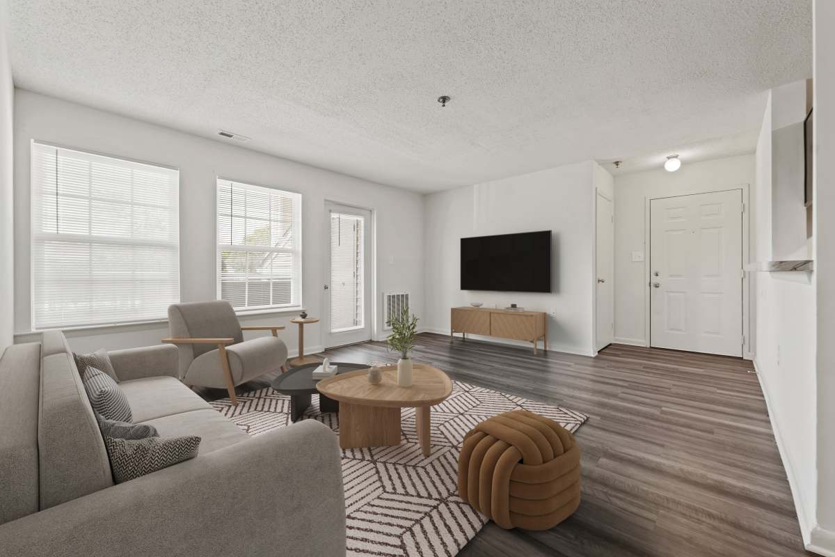 Spacious living area with wood-style flooring at Lee Overlook Apartments in Centreville, Virginia 