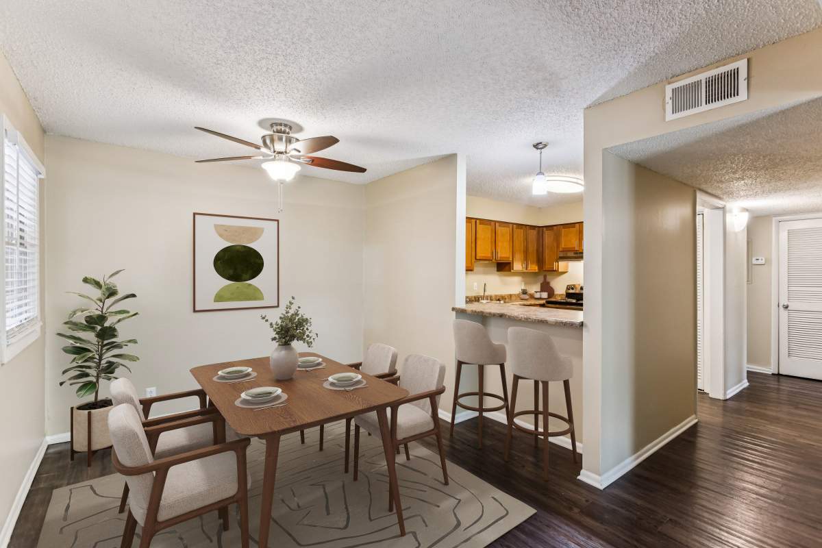 Model dining space with kitchen bar at Ashford Place in Clarksville, Tennessee