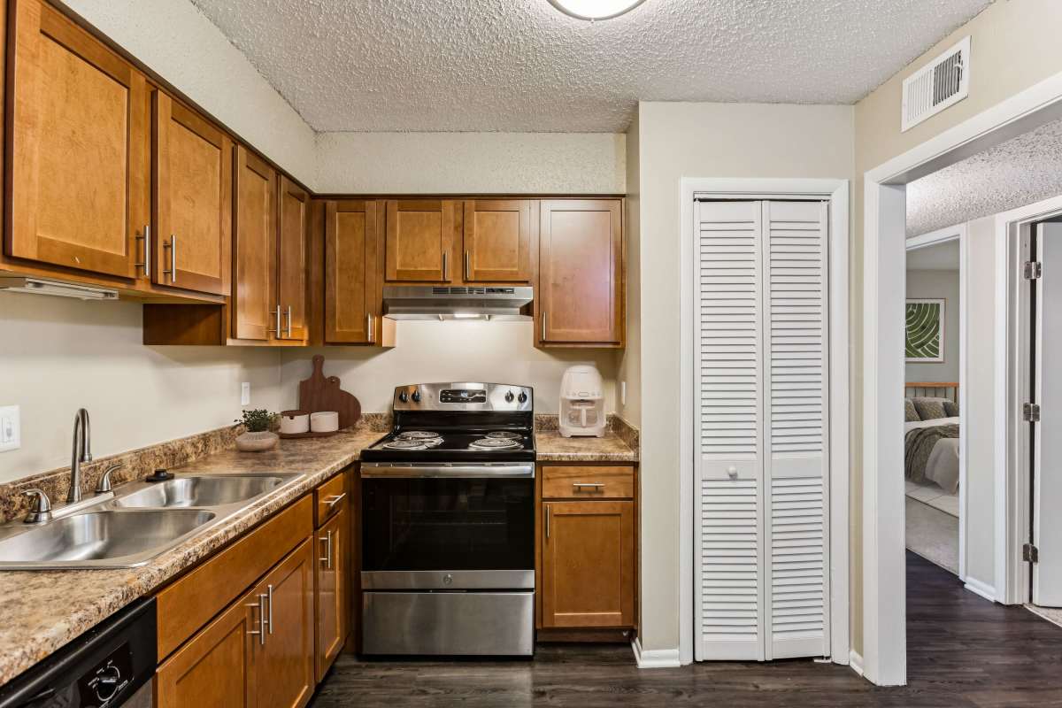 Model kitchen with stainless steel appliances and pantry at Ashford Place in Clarksville, Tennessee