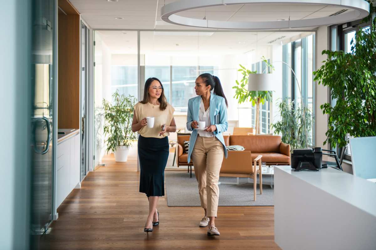 Two women carrying coffee cups at Peters Residential in Culver City, California