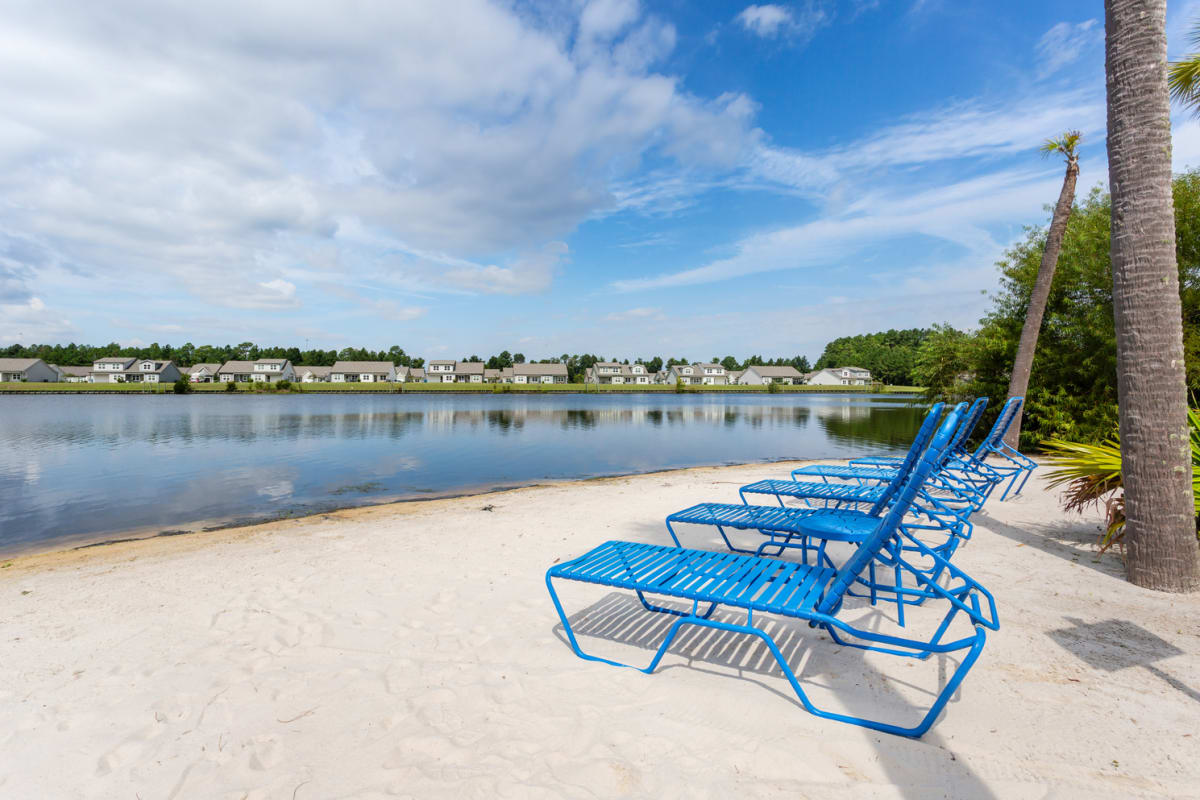 lounge chairs by a lake