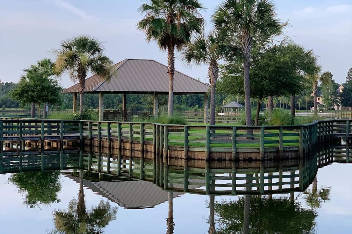 a gazebo and pier by a lake