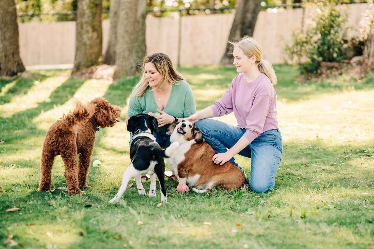Resident friends playing with their pet in the park at The Heights at Waterpointe in Flowood, Mississippi