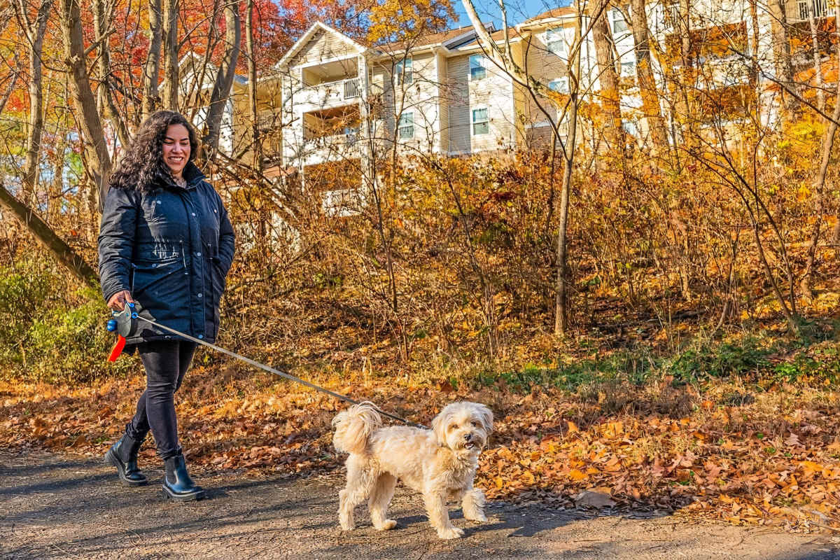  Happy resident family with their pet dog at Lee Overlook Apartments in Centreville, Virginia