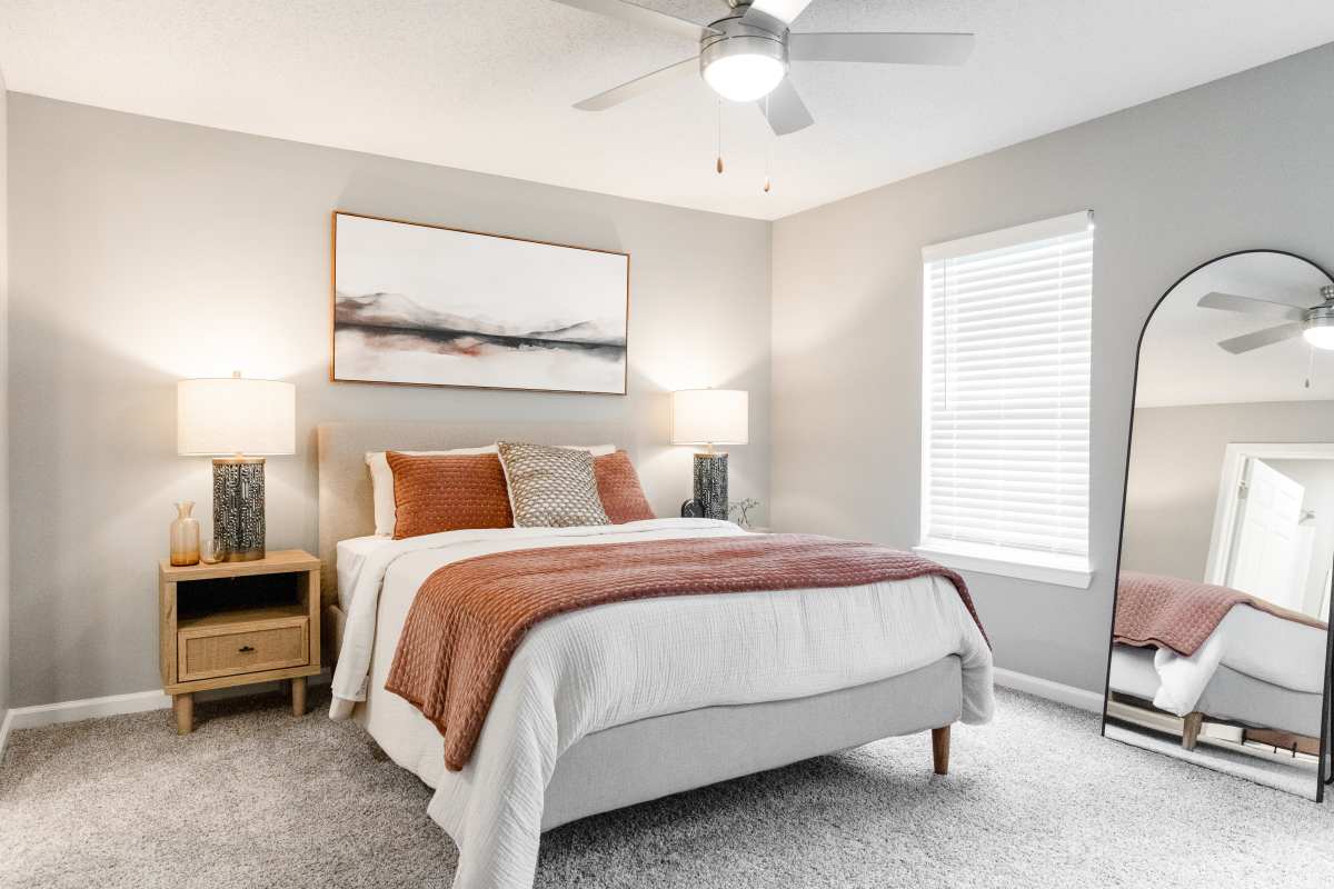 Model bedroom with ceiling fan at Atlas at Goodlett Farms in Cordova, Tennessee