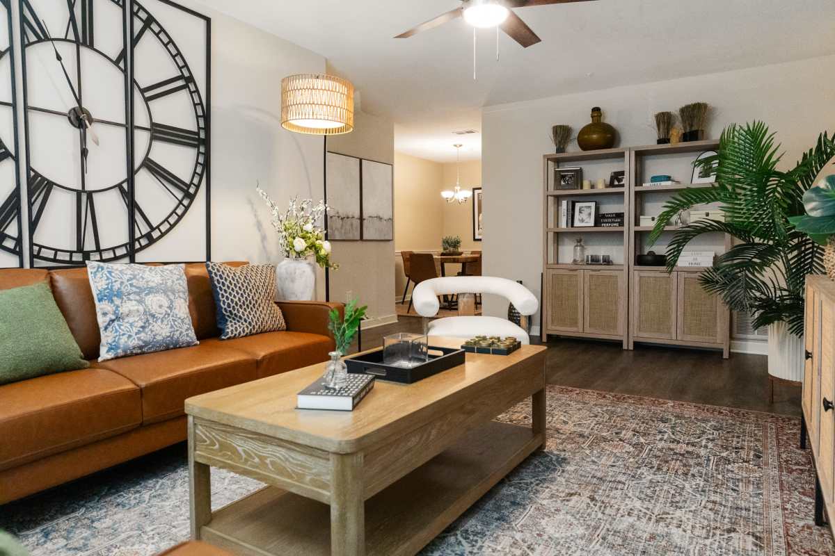 Model living space with ceiling fan at The Landings at Houston Levee in Cordova, Tennessee