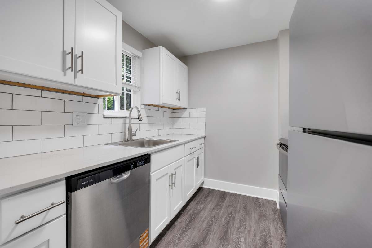 Modern kitchen with stainless steel appliances at Valley Brook Townhomes in Rochester, New York