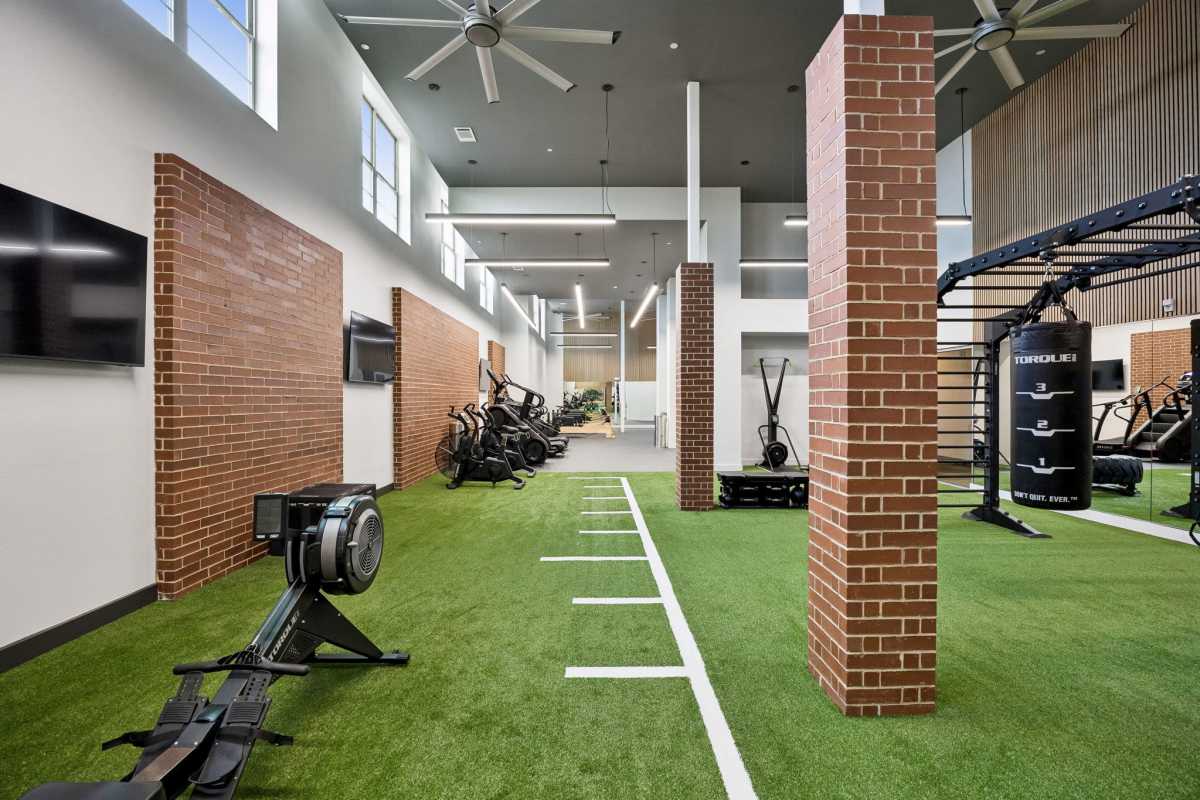 Fitness center with cardio equipment at The Margaret at Riverfront in Dallas, Texas