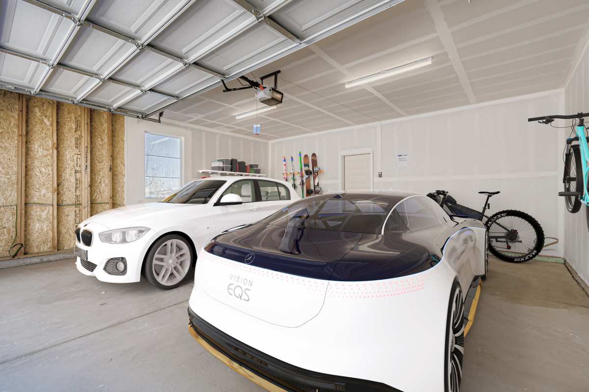 Two cars inside a private garage with room for storage