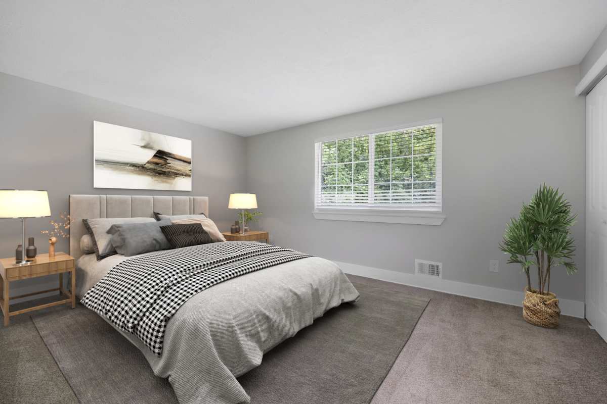 Cozy bedroom with natural light at Valley Brook Townhomes in Rochester, New York