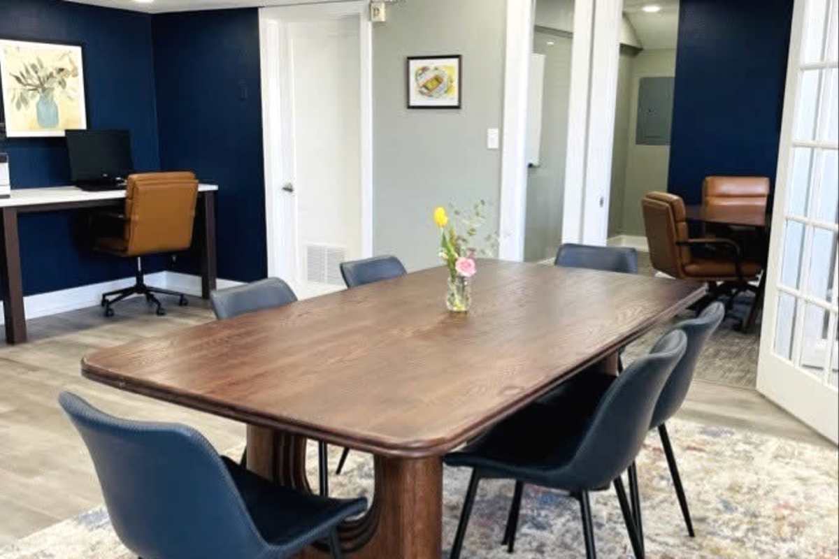Collaborative workspace with meeting table and study area at Hawks Pointe in Lawrence, Kansas