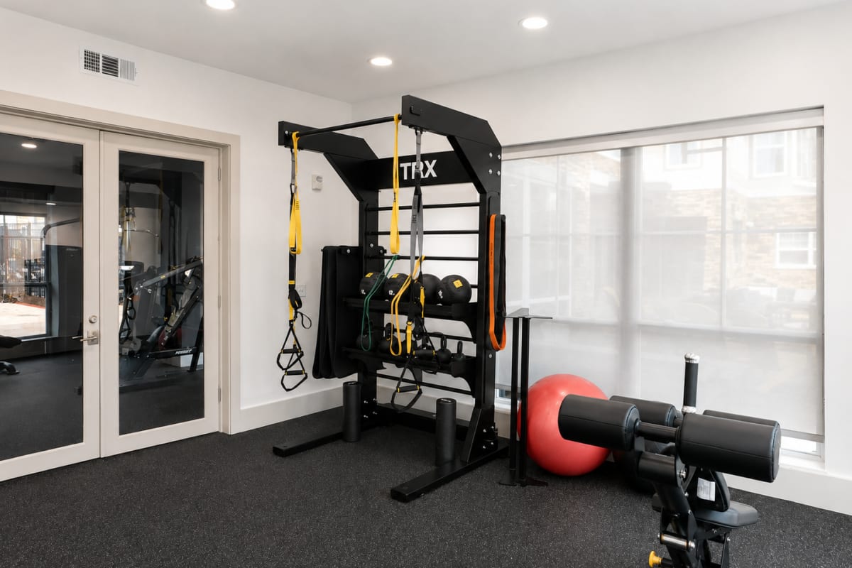 Private fitness room with weights and training equipment at The Den in Columbia, Missouri