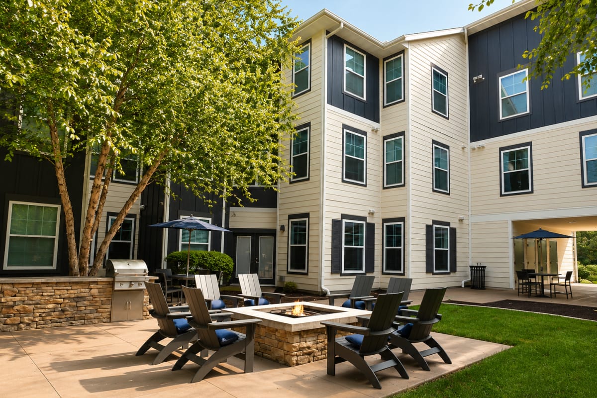 Outdoor courtyard with fire pit and seating area at The Den in Columbia, Missouri