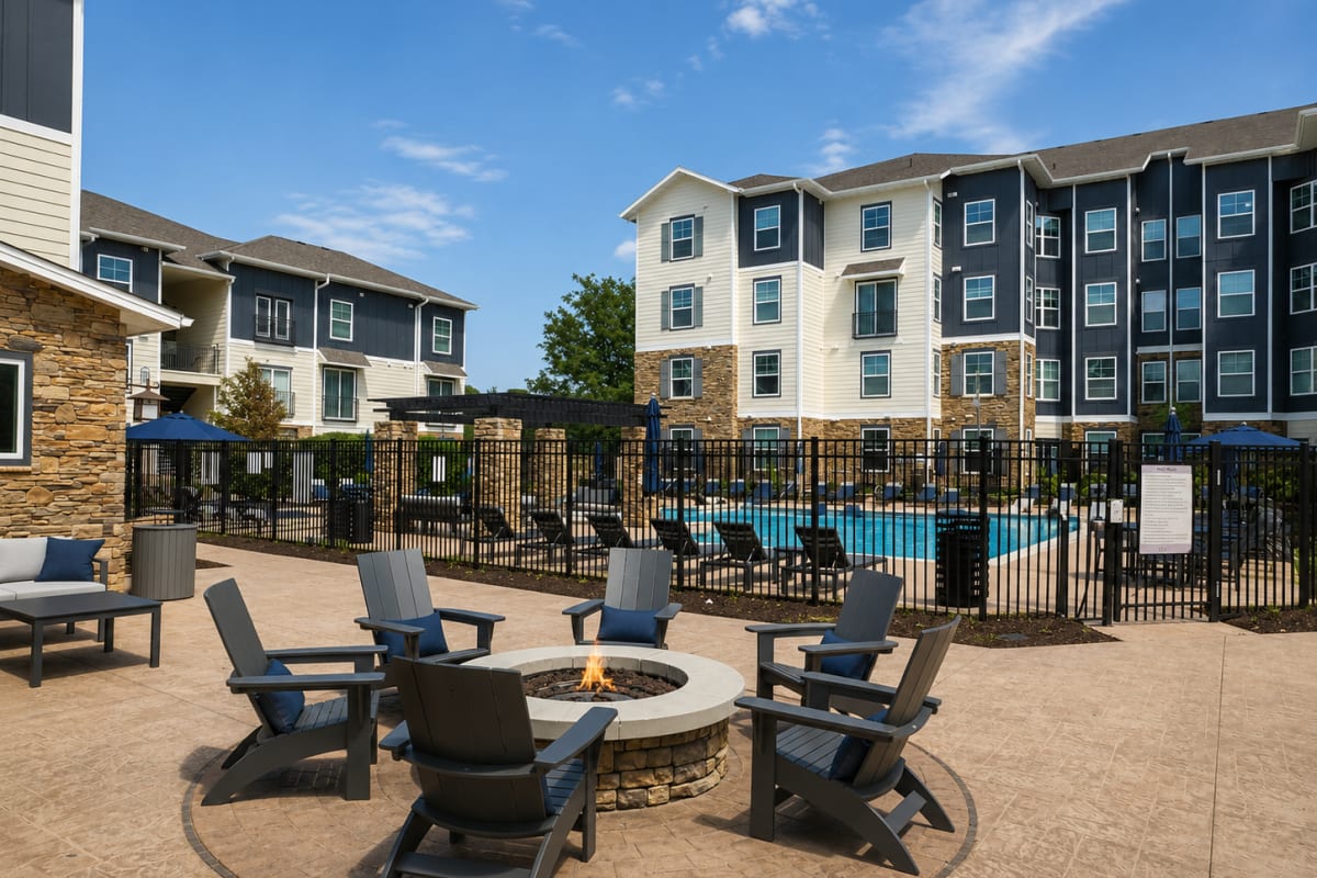 Resort-style pool deck with lounge seating at The Den in Columbia, Missouri