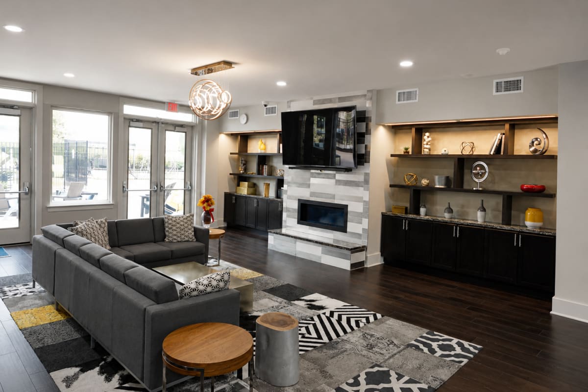 Student lounge with seating, fireplace, and study space at The Den in Columbia, Missouri