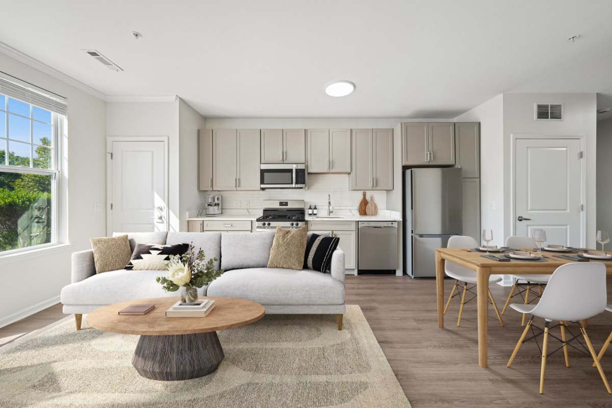 Modern living room area with view of newly renovated kitchen and dining table at Grove at Somerset in Somerset, New Jersey