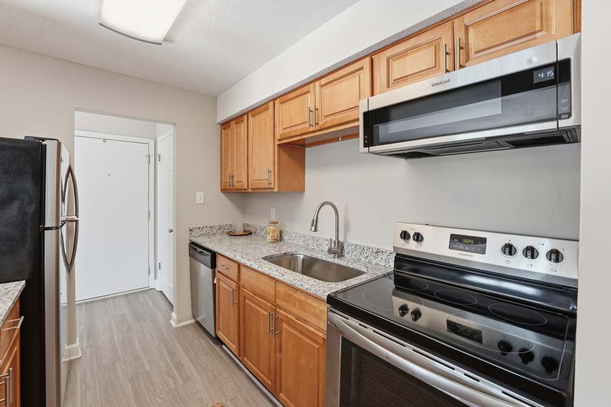 Preparing food on a granite countertop at Collins Crossing Apartments in Carrboro, North Carolina