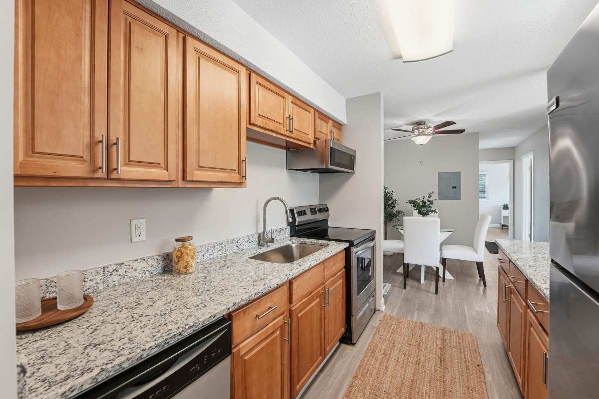 Glass dining table with patterned chairs at Collins Crossing Apartments in Carrboro, North Carolina