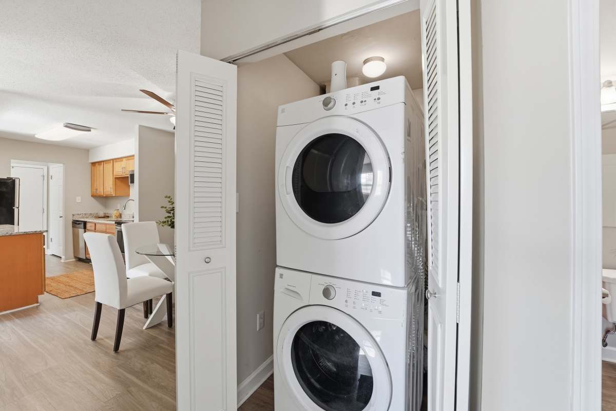 White bathtub with shower curtain and towel at Collins Crossing Apartments in Carrboro, North Carolina