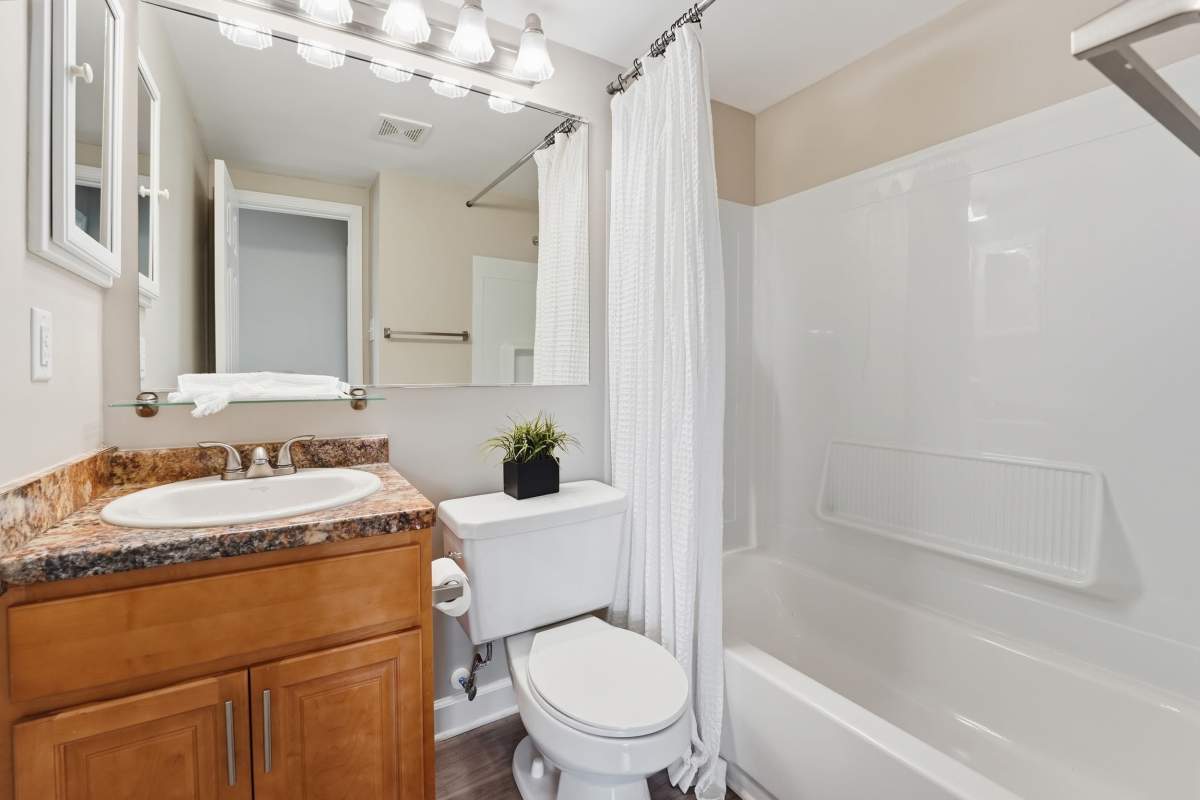 White towels are neatly arranged on a shelf at Collins Crossing Apartments in Carrboro, North Carolina