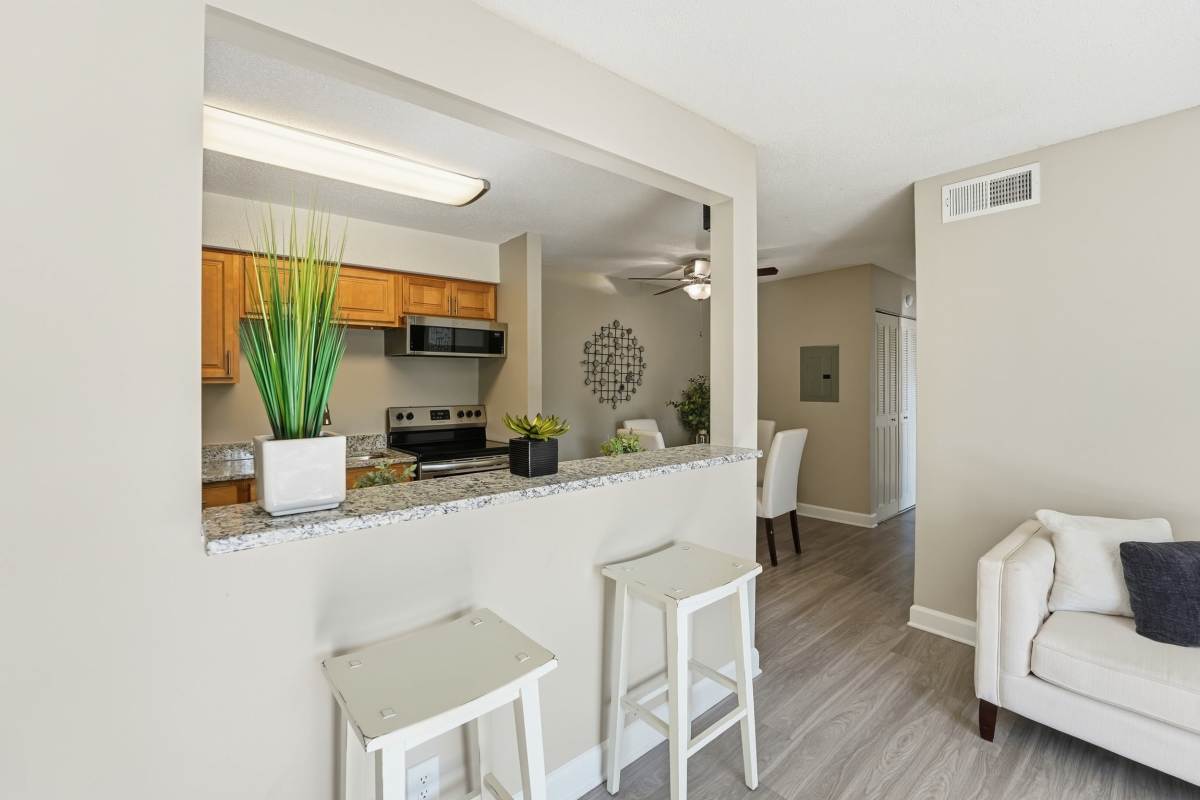 Stacked washer and dryer in hallway at Collins Crossing Apartments in Carrboro, North Carolina