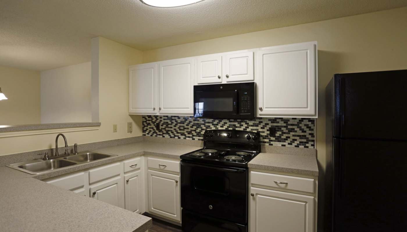 Well-equipped kitchen with black appliances at Camellia Trace in Jackson, Tennessee