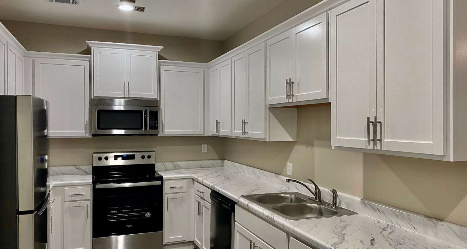 Kitchen with white cabinetry in a model home at Patriots Place in Valdosta, Georgia