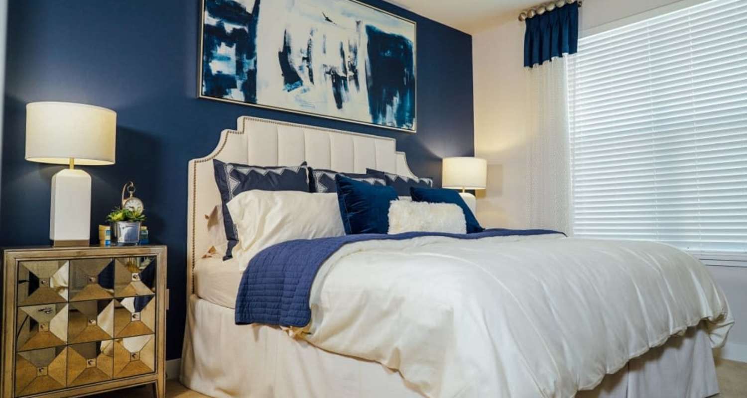 Cozy bedroom with bedside lamp at Mayfair Reserve in Wauwatosa, Wisconsin
