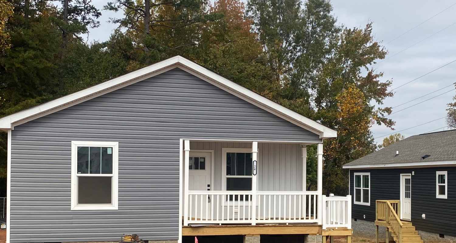 Gray house with front porch in neighborhood Tapestry Homes in Hickory, North Carolina