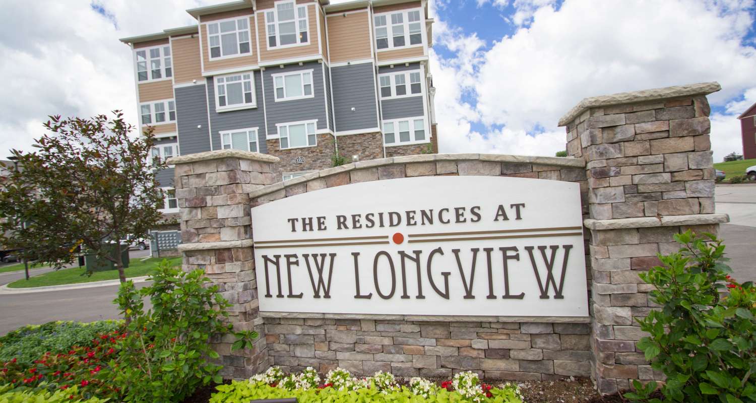 Entrance with sign at The Residences at New Longview in Lee's Summit, MO