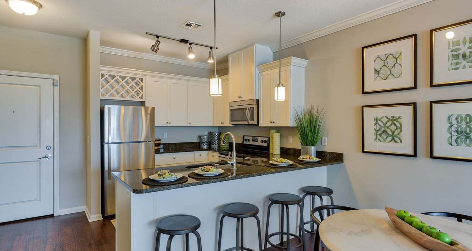 kitchen with bar stools at The Residences at New Longview in Lee's Summit, MO